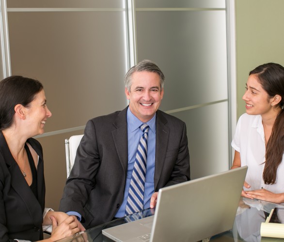 Mature business man with team members in an office